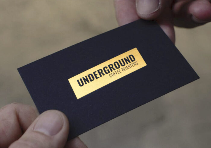 Image of business development & sales team member handing over Underground Coffee Roasters business card